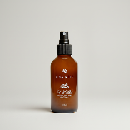 Flacon brun ambré de 120ml avec spray noir, étiquette blanche oréra tonique floral.
